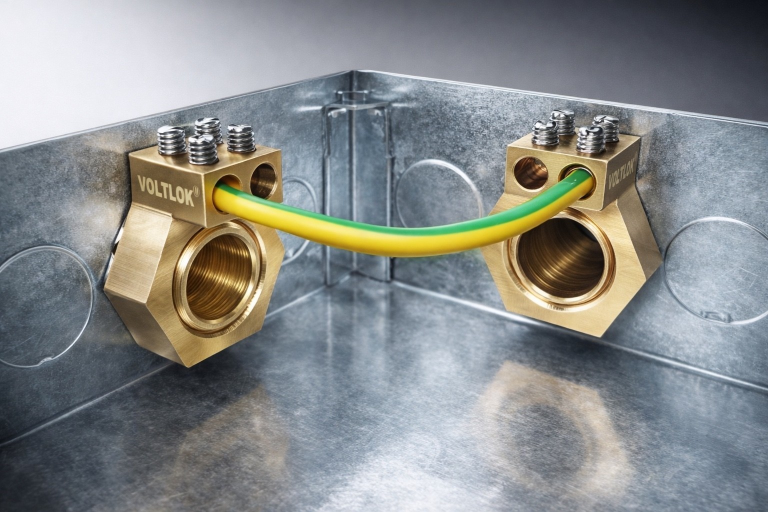 Two VOLTLOK brass earthing nuts installed in a metal enclosure with earth conductor